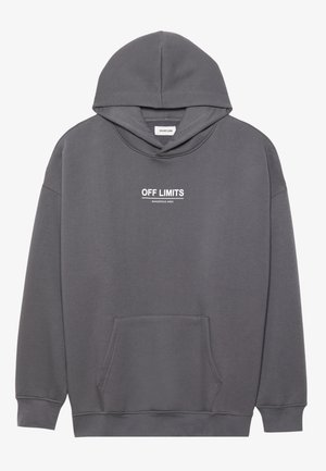 Sweatshirt à capuche grise en tissu mélangé coton. Caractérisé par une poche avant et un texte blanc : "ZONE DANGEREUSE INTERDITE" imprimé sur la poitrine.