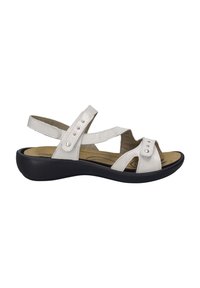White sandal with cross straps and adjustable closures, featuring metallic accents. Cushioned footbed and black rubber sole.