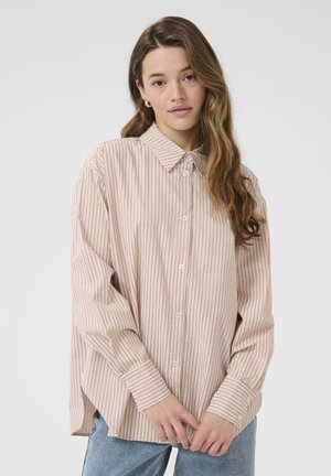 Blush pink button-up shirt with vertical stripes, classic collar, and cuffed long sleeves. Soft fabric with a relaxed fit.