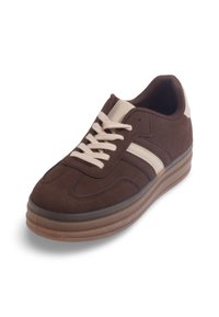 Baskets en daim marron avec des accents et des lacets crème. Forme arrondie, semelle rembourrée et deux rayures parallèles sur les côtés pour le style.