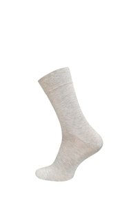 Chaussette en coton beige avec une bande supérieure côtelée, texture lisse et hauteur de cheville. Aucun motif ni graphique visible.
