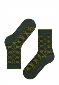 Grüne Socken mit einem gelben geometrischen Muster, ausgestattet mit einer glatten Textur und gerippten Bündchen. Der Markenname "FALKE" ist auf der Sohle sichtbar.