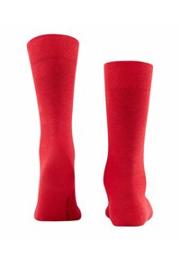 Rote Baumwollkniestrümpfe in knielanger Form mit glatter Textur und gerippten Bündchen. Keine sichtbaren Muster oder Beschläge, einfaches und einheitliches Design.