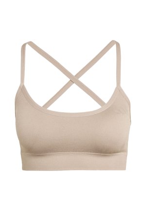 Reggiseno sportivo beige senza cuciture con spalline incrociate sottili e ampia fascia sotto il seno a costine, progettato per comfort e supporto leggero.