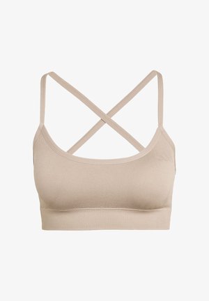 Reggiseno sportivo beige senza cuciture con spalline incrociate sottili e ampia fascia sotto il seno a costine, progettato per comfort e supporto leggero.