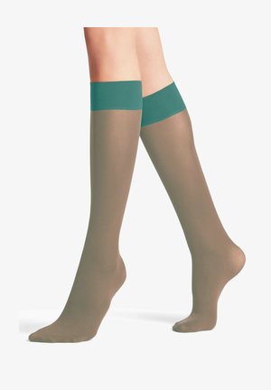 Kniestrümpfe, transparentes Beige mit mattem Finish, mit einem festen petrolfarbenen Bund oben. Glatte Textur und figurbetontes Design.