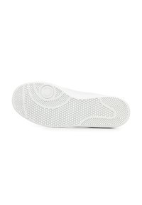 Suela de zapatilla blanca con patrón hexagonal, que presenta una textura suave y bordes curvados, incluye un detalle de marca circular.