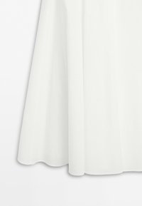 White fabric with a smooth texture hanging with a subtle flare at the bottom edge on a neutral background.