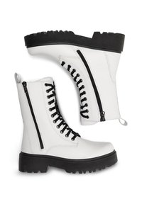 Baltas ādas potītes zābaki ar melniem auklām un rāvējslēdzējiem, ar masīvu melnu zoli un cilpu aizmugurē ērtai uzvilkšanai.