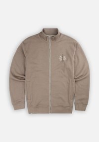 Veste zippée marron en tissu doux, dotée d'un col haut, de deux poches latérales et d'un design graphique de flocon de neige blanc sur la poitrine.