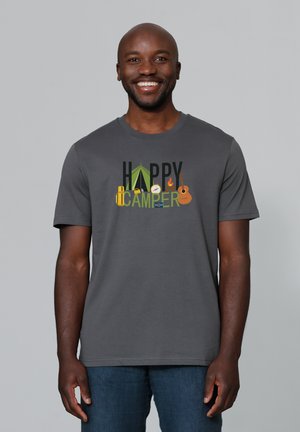 T-shirt gris à manches courtes avec le texte "HAPPY CAMPER" et des graphiques sur le thème du camping, incluant une tente, une boussole et une guitare.