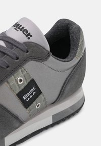 Baskets Blauer U.S.A. gris et gris foncé avec panneaux en daim et texture, lacets noirs et col rembourré.
