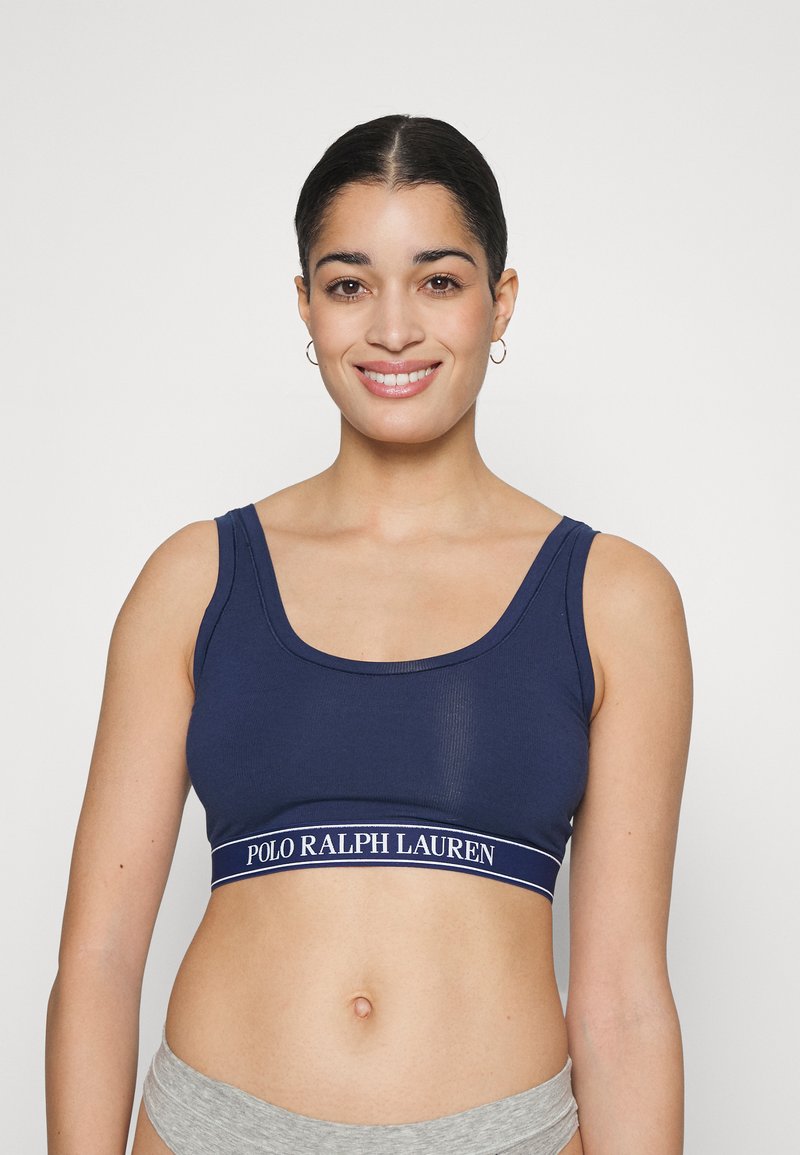 Navy cotton blend sports bra featuring a scoop neckline and wide band with white "POLO RALPH LAUREN" logo. Smooth texture and fitted design.