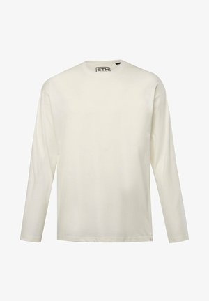 Camiseta de manga larga y cuello redondo en un color crema claro. Fabricada en suave algodón, presenta un ajuste estándar con detalles de diseño mínimos.