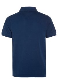 Námořnická modrá polo košile vyrobená z texturované bavlny, s klasickým límečkem a krátkými rukávy. Zadní pohled, bez viditelného brandingu nebo akcentů.