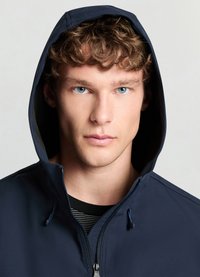 Navy blue hooded jacket with a zipper and drawstring, made of smooth material. Features a striped black and white inner lining.