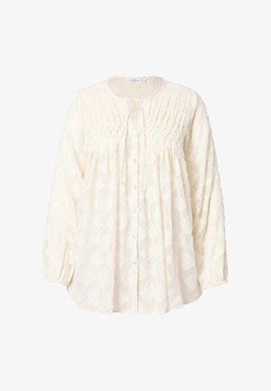 Valkoinen pitkähihainen pusero, jossa on nappikiinnitys edessä, teksturoitu kangas geometrisella kuviolla ja kootut yksityiskohdat pääntiellä.