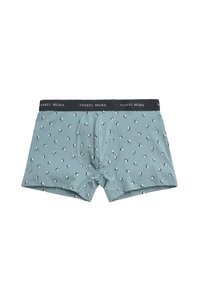 Boxer ajustados para hombre de color azul claro con una cinturilla negra etiquetada "Ysabel Mora" y un pequeño patrón de perros en blanco y negro por todas partes.