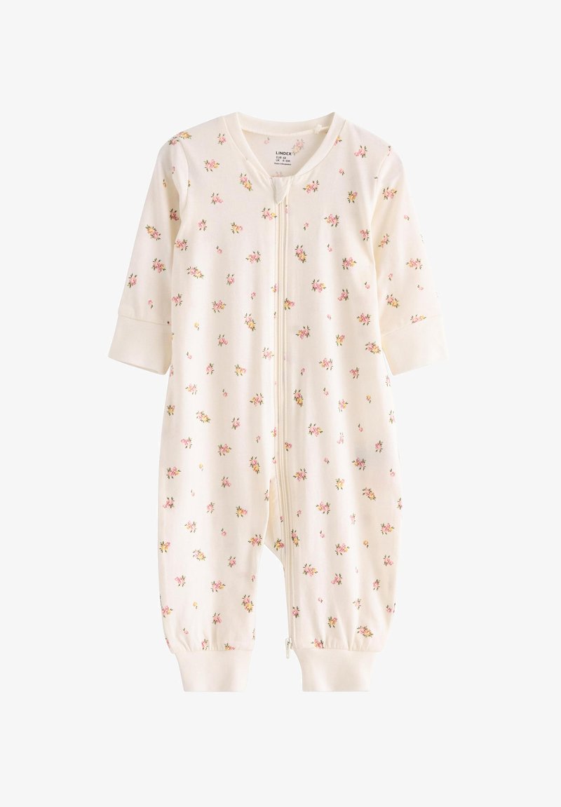 Gaiši krēmkrāsas kombinezons ar nelieliem, izkaisītiem ziedu rakstiem rozā un dzeltenā krāsā, garām piedurknēm ar aproču apmalēm un priekšpuses rāvējslēdzēja aizdari.