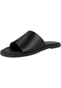 Sandale en cuir noir à glissière avec un design à bout ouvert, texture lisse et détails cousus sur la semelle. Base plate sans talon.