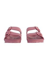 Pink rubber slides with two adjustable buckles, flat soles, and a smooth texture, featuring a simple, open design.