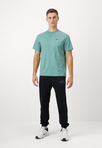 Nike Performance JOGGER - Tepláky - black/white