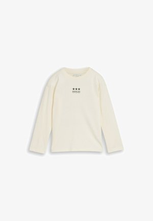 Off-white shirt met lange mouwen met drie zwarte sterren en het woord "GO PLAY" gedrukt in kleine cirkels op de borst.