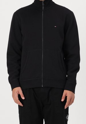 Black zip-up sweatshirt made of soft fabric featuring a high collar, two front pockets, and a small logo on the left chest.