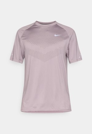 Light purple athletic t-shirt made from soft, breathable fabric. Features a textured pattern on the front and short sleeves. Nike logo on the chest.