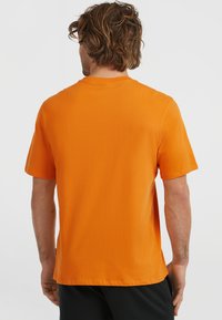 Orange short-sleeve t-shirt made from cotton, featuring a crew neck and a smooth texture, with a straight hem and minimal design details.