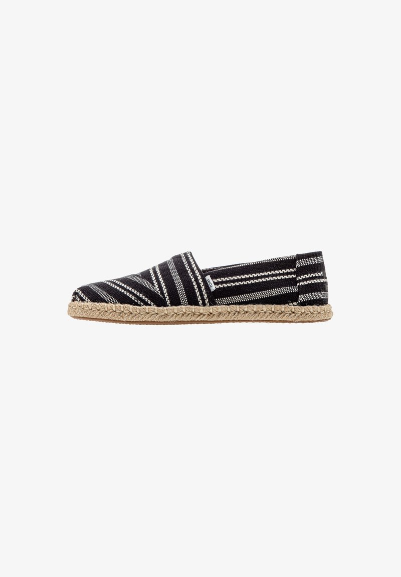Black and white striped espadrille with a woven textile upper, closed toe, jute midsole, and flat rubber sole.