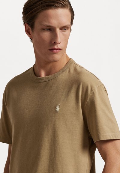 Kortärmad t-shirt med rund hals i taupe-bomull med en strukturerad yta, med en liten broderad logotyp på vänstra bröstet.