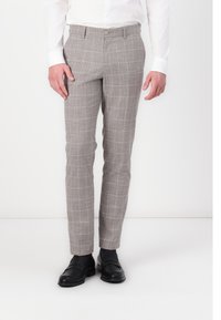Grau karierte Hose aus einem strukturierten Stoff, mit schlanker Passform und Fronttaschen, kombiniert mit schwarzen Mokassins.