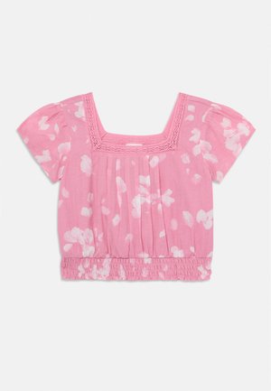 Blusa rosa a maniche corte con stampe floreali bianche, scollo quadrato in pizzo, davanti plissettato e orlo elastico raccolto.