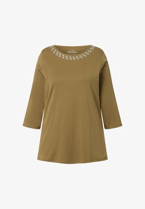 Oliwkowa tunika z rękawami o długości trzech ćwiartek, okrągłym dekoltem ozdobionym koralikową lamówką i luźnym krojem. Miękka tekstura materiału.