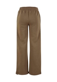 Braune, weite Sweatpants mit strukturiertem Finish. Elastischer Bund und seitliche Taschen. Einfaches und funktionales Design.