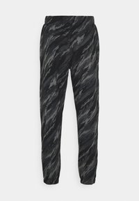 Svart- och gråmönstrade träningsbyxor med elastisk midjeband, avsmalnande benslut och ett texturerat, vågigt mönster över hela.