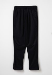 Schwarze Sporthose aus glattem Stoff, mit einem elastischen Bund, Seitentaschen und Reißverschlüssen an den Knöcheln.