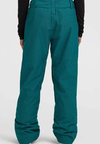 Teal snöbyxor med en texturerad yta, med avslappnad passform, elastisk midja och subtil sömdetaljer.