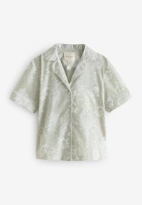 Lyhythihainen pyjama-toppi vaaleanvihreästä kankaasta, jossa on kukkakuosi, valkoiset reunat ja rintatasku, varustettuna nappikiinnityksellä edessä.