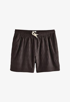 Chiloți de baie negri, texturați, cu talie elastică și șnur alb legat în nod în fața, în centru.