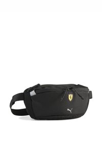 Banane noire en nylon texturé, dotée d'un compartiment principal zippé, d'une sangle réglable, du logo Ferrari et du branding Puma sur le côté.