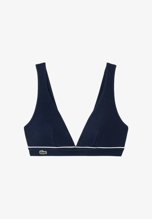 Top bikini triangolare blu navy con spalline larghe, bordo bianco lungo il fondo e piccolo logo verde del coccodrillo sulla fascia.