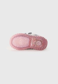 Shoe sole with a transparent pink rubber base, featuring ridged texture and a smooth surface, designed for traction and comfort.