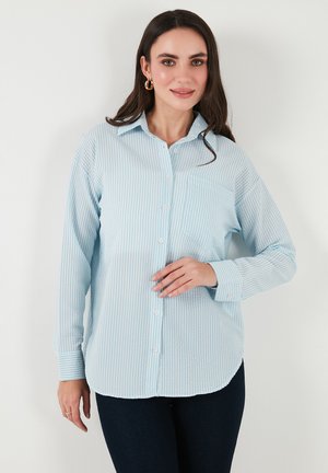 Light blue button-up shirt with white vertical stripes, collar, pocket on the left chest, and long sleeves with buttoned cuffs.