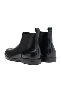 Svarta läder Chelsea-boots med elastiska sidopaneler, rund tå och dragflikar på baksidan; slät yta med en glänsande finish.