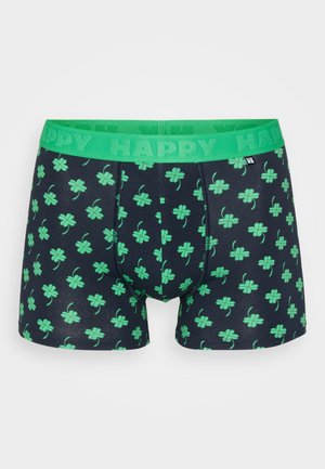 Boxerky s elastickým pasem v zelené barvě označeným nápisem "HAPPY." Mají tmavě modré pozadí se vzorem zelených čtyřlístků rozptýlených po celé ploše.