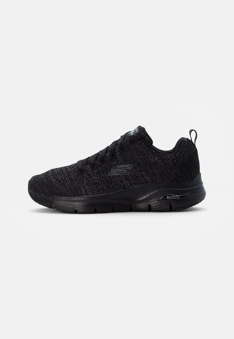 Black athletic shoe with a mesh upper, lace-up design, cushioned sole, and textured accents. Features ArchFit branding on the side.