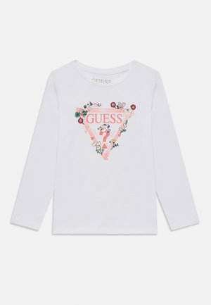 Camisa de manga longa branca com um gráfico triangular rosa com detalhes florais e o logo "GUESS" ao centro. Material de algodão suave.