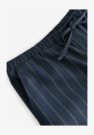 Tumestriibid ja elastse vöökohtaga ja nööriga joggers. Omab vertikaalseid valgeid triipe ja siledat tekstuuri.